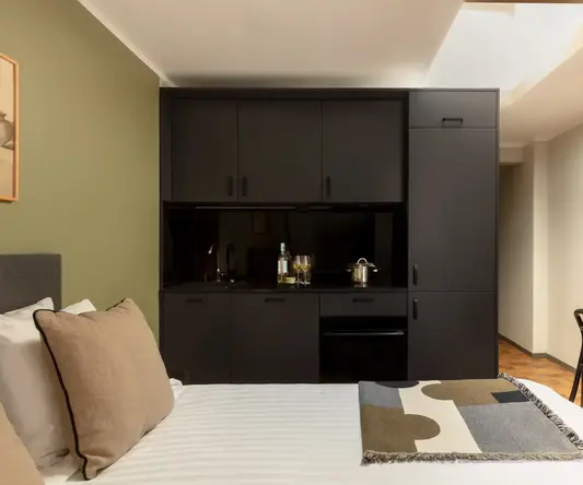 a bed with a black cabinet and a blanket
