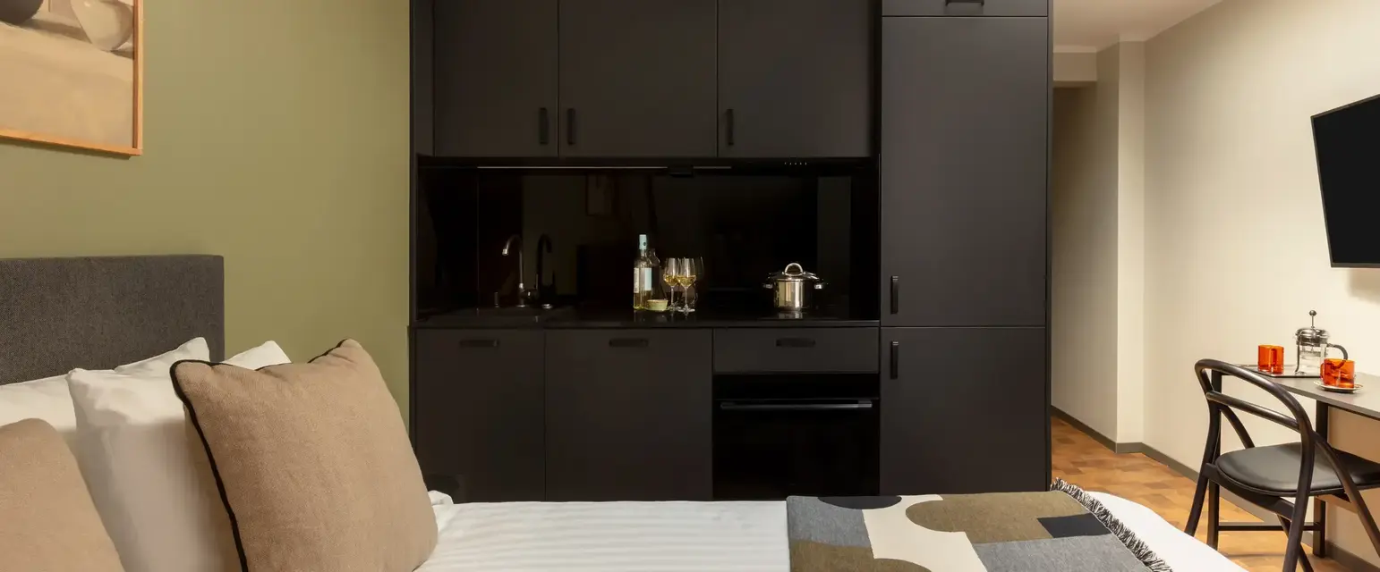 a bed with a black cabinet and a blanket