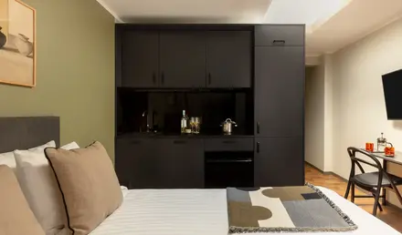 a bed with a black cabinet and a blanket