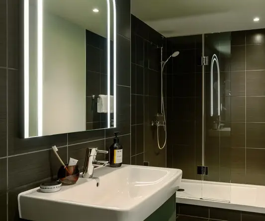 a bathroom with a mirror and sink
