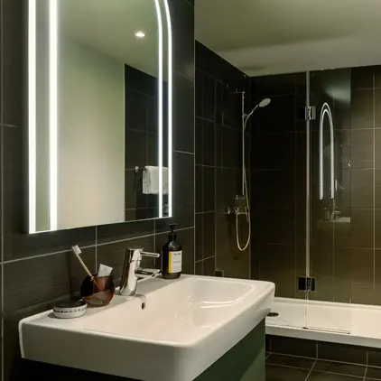 a bathroom with a mirror and sink