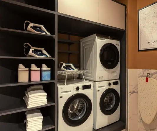 a laundry room with a stack of dryers and a dryer