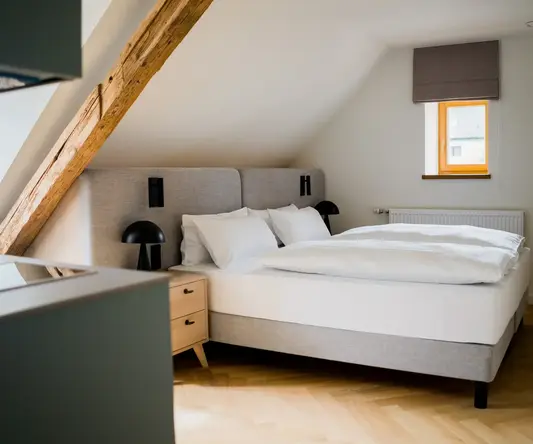 a bedroom with a bed and a table