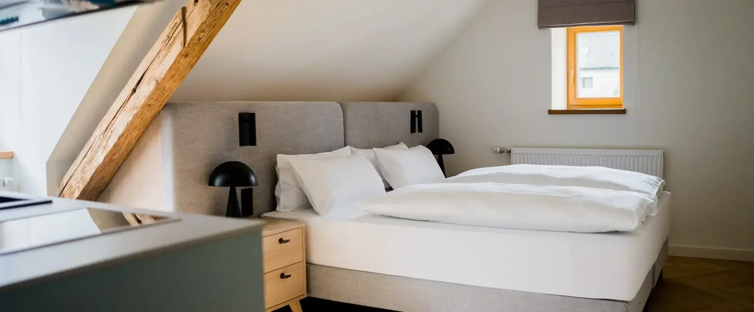 a bedroom with a bed and a table