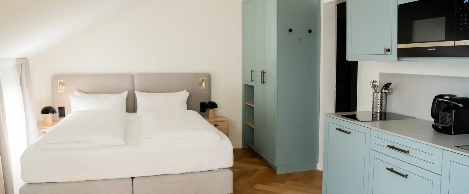 a bedroom with a bed and cabinets