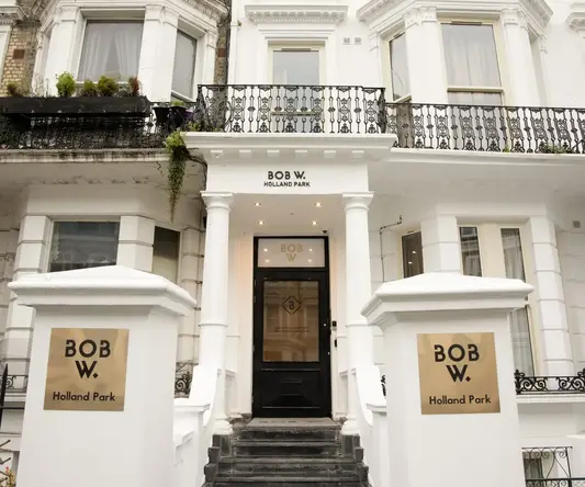 a building with a black door and white pillars