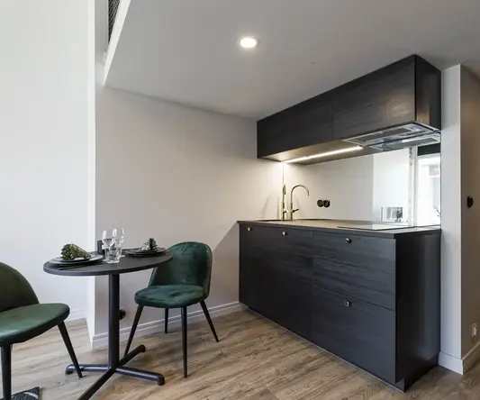 a kitchen with a table and chairs