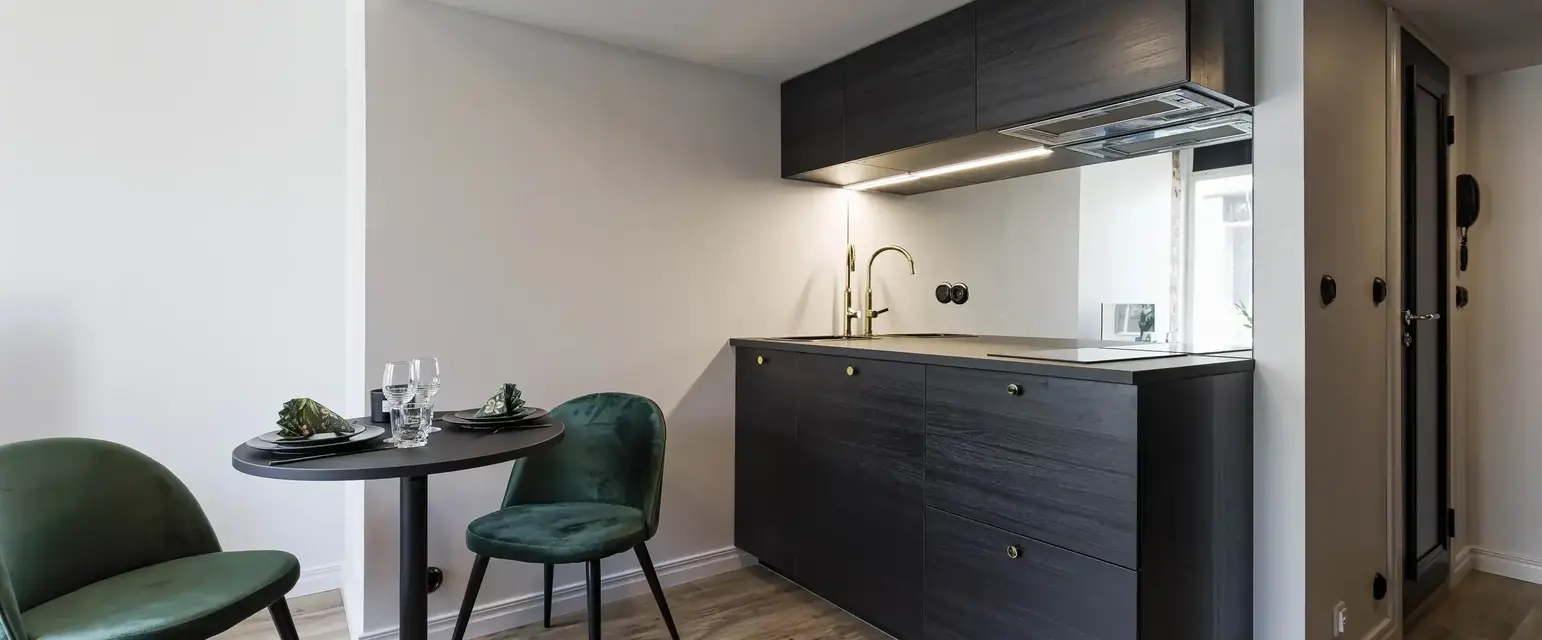 a kitchen with a table and chairs