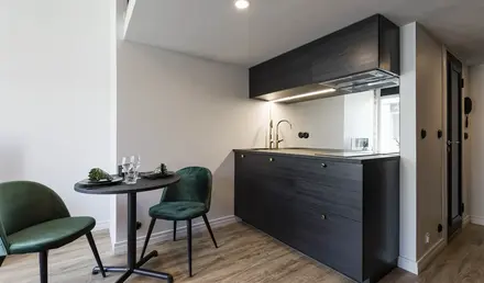 a kitchen with a table and chairs