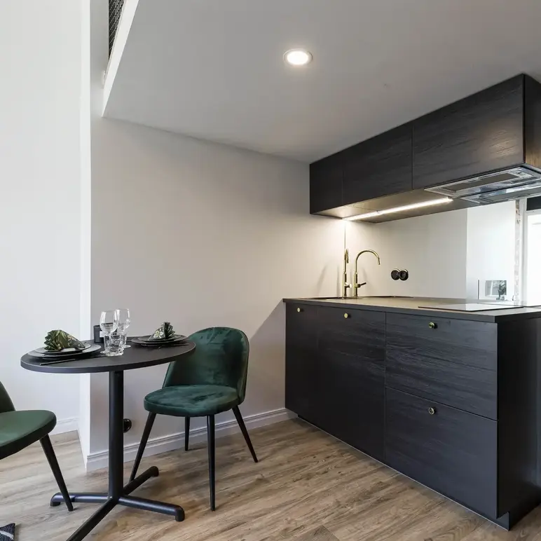 a kitchen with a table and chairs