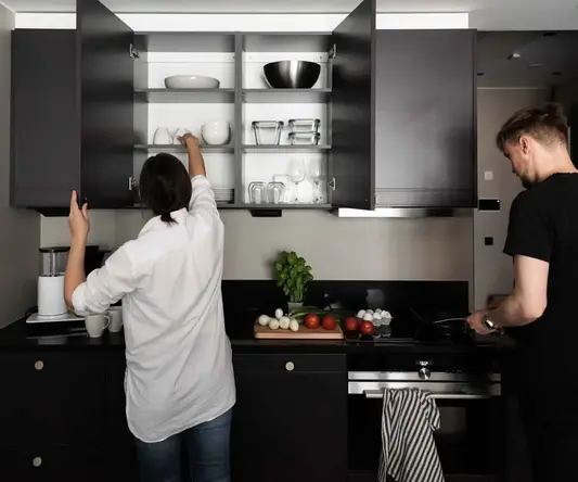 a man and woman in a kitchen