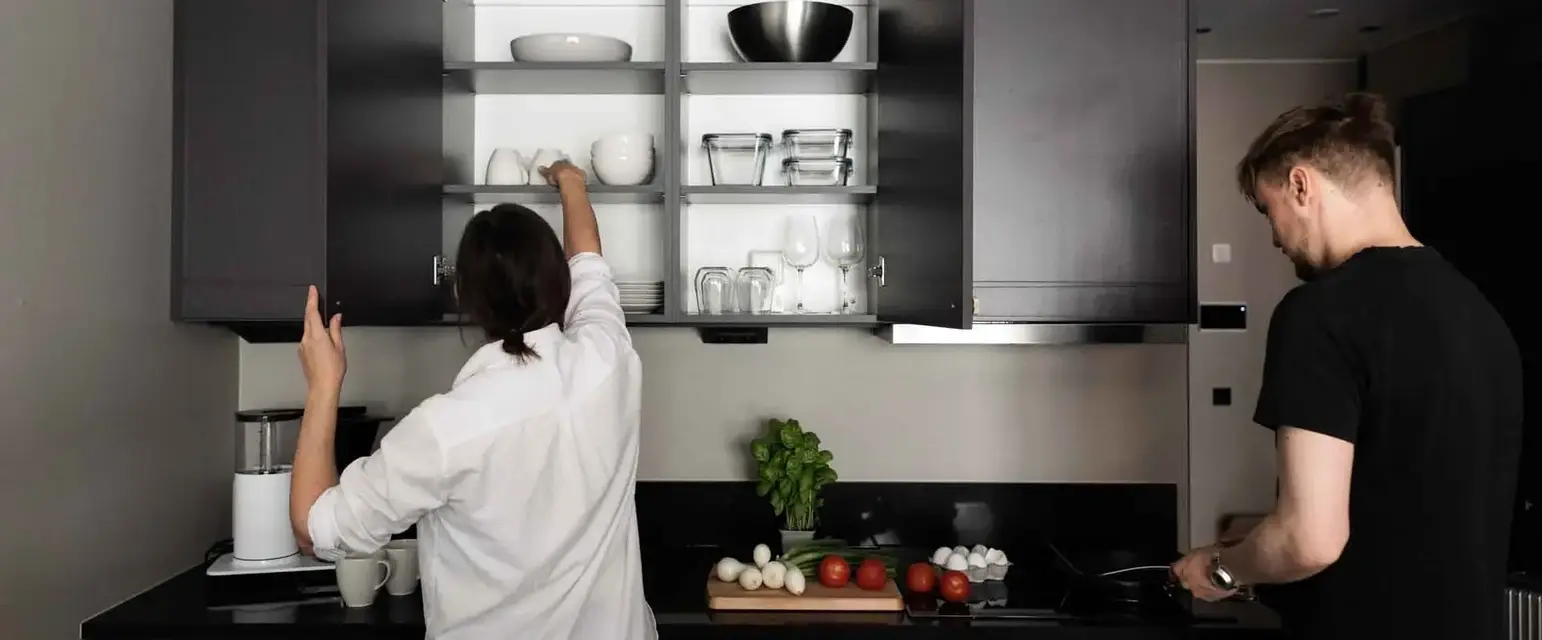 a man and woman in a kitchen