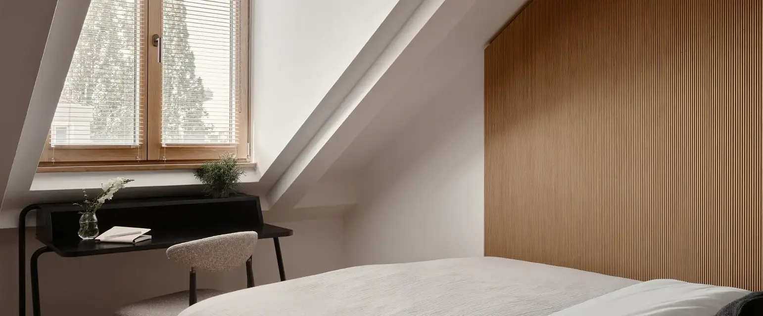a bed in a room with a desk and a piano