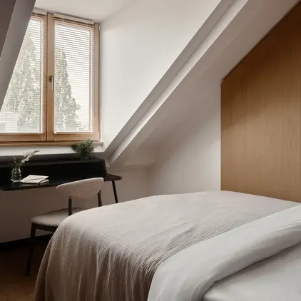 a bed in a room with a desk and a piano
