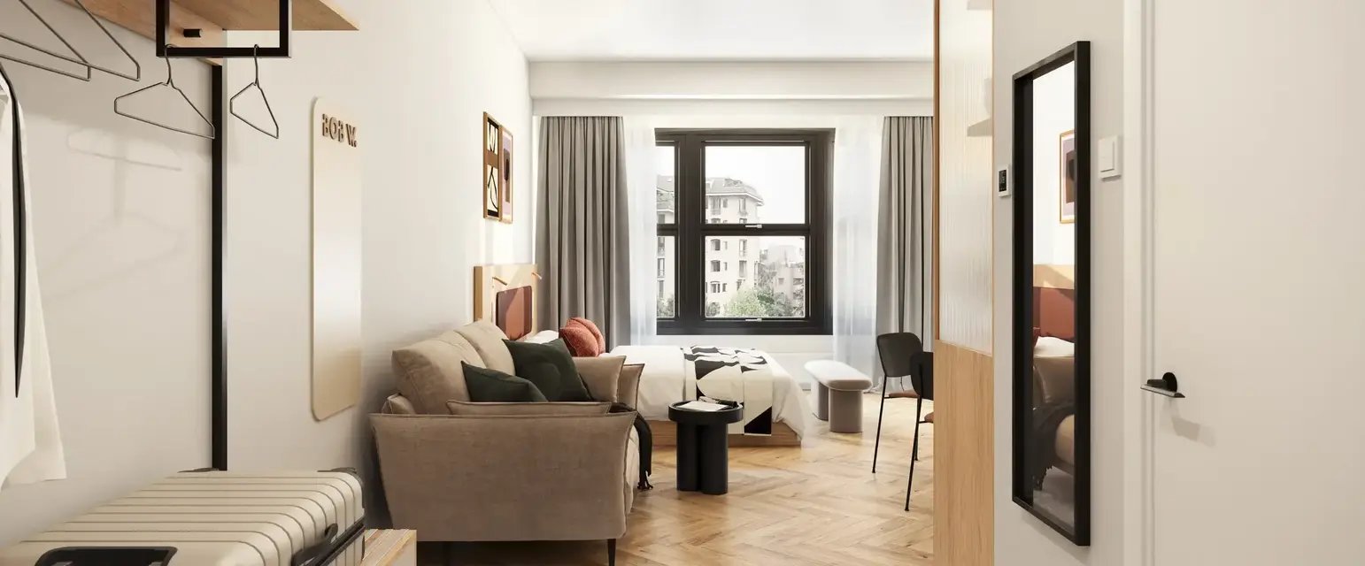 a room with a couch and a suitcase