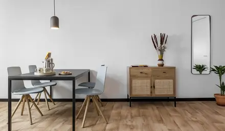 a dining table and chairs in a room