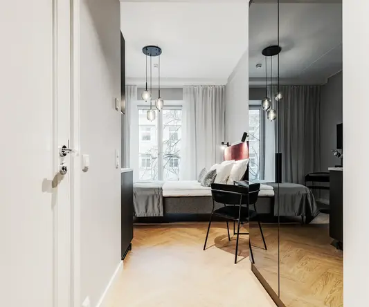 a bedroom with a mirror and a bed