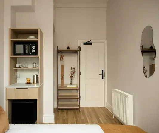 a room with a door and a microwave