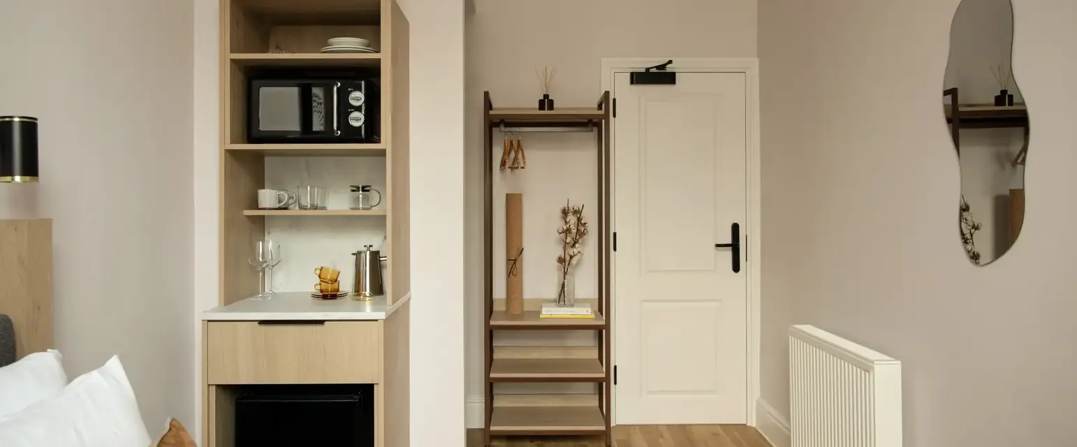 a room with a door and a microwave