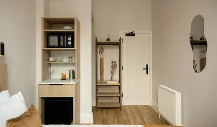 a room with a door and a microwave