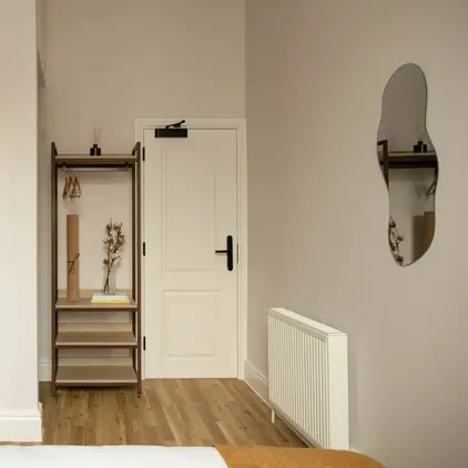 a room with a door and a microwave