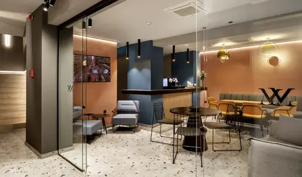 a room with glass walls and tables and chairs