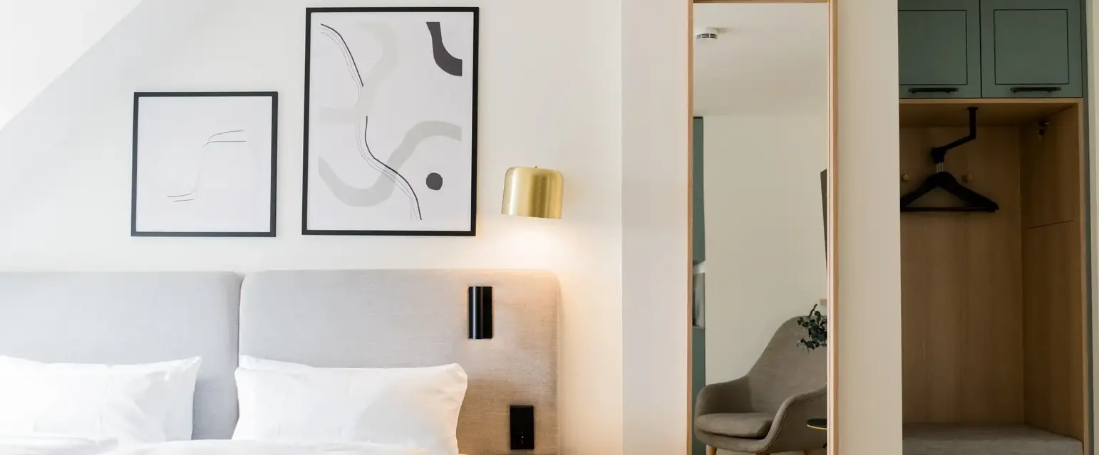 a mirror next to a bed