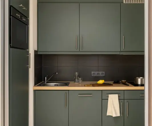 a kitchen with grey cabinets and a sink