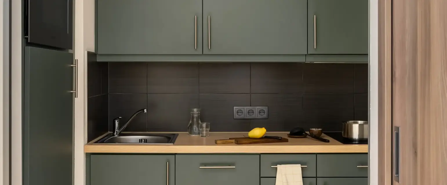 a kitchen with grey cabinets and a sink