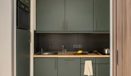 a kitchen with grey cabinets and a sink
