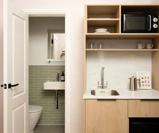 a kitchen with a sink and a toilet