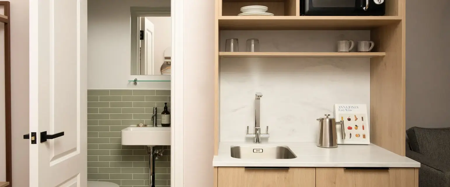 a kitchen with a sink and a toilet