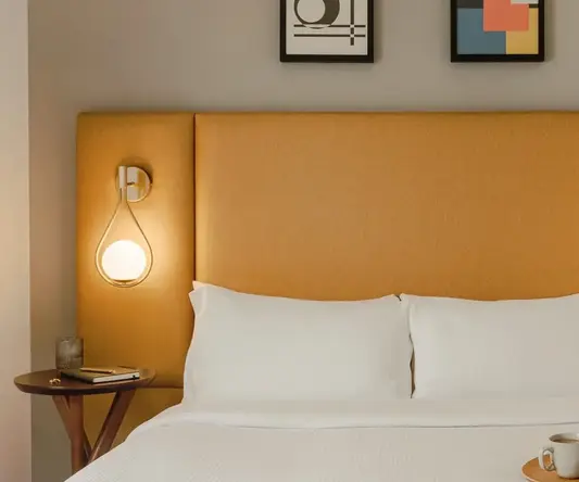 a bed with a tray of food on it