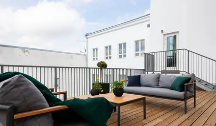 a patio with a couch and a table
