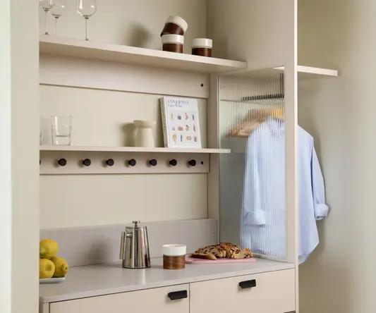 a white kitchen with a glass door
