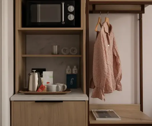 a shelf with a microwave and a shirt on it