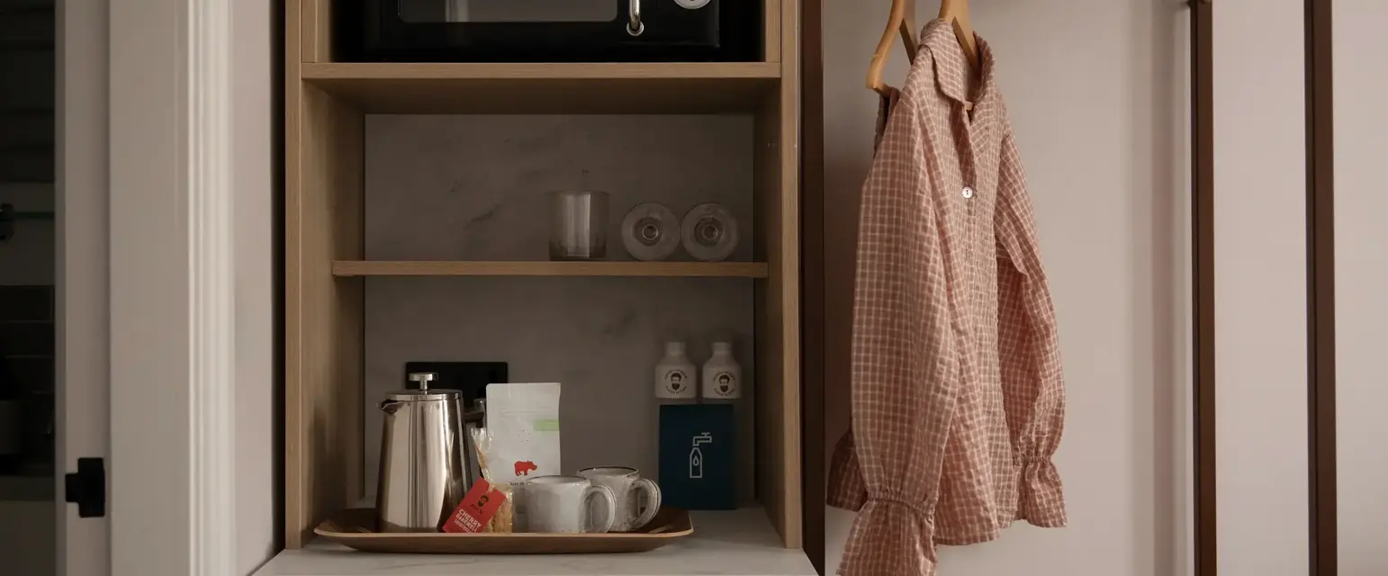 a shelf with a microwave and a shirt on it