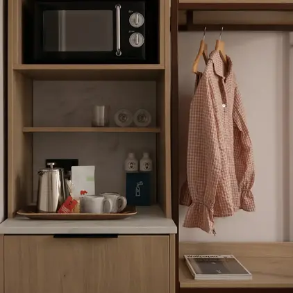 a shelf with a microwave and a shirt on it