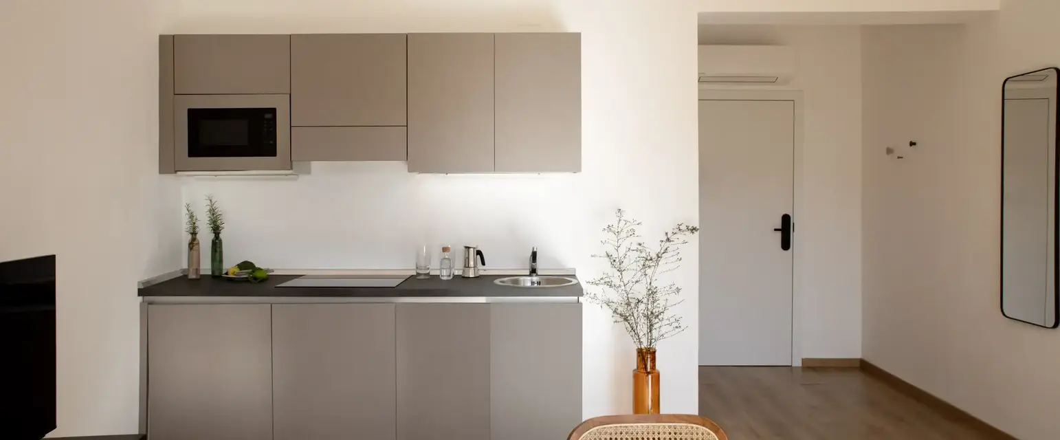 a kitchen with a table and chairs