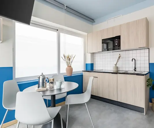 a kitchen with a table and chairs