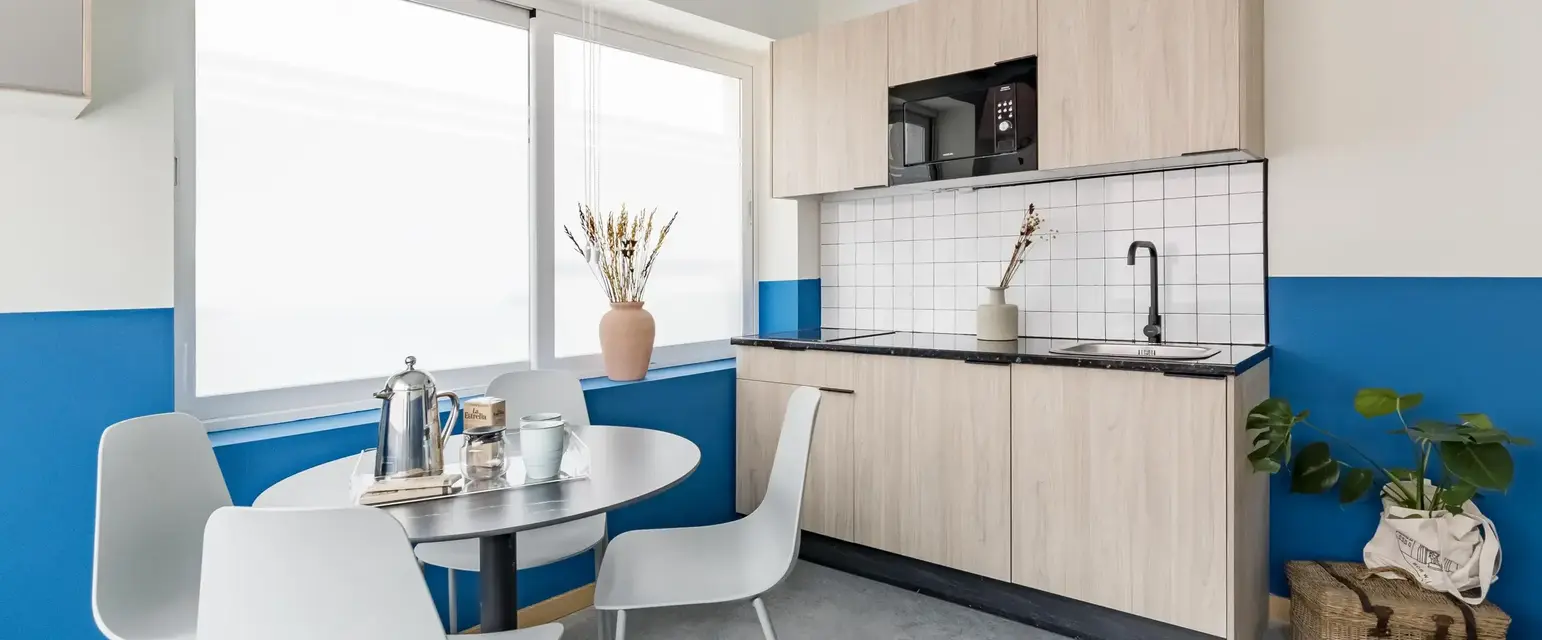a kitchen with a table and chairs