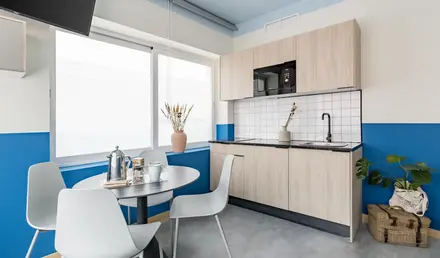 a kitchen with a table and chairs