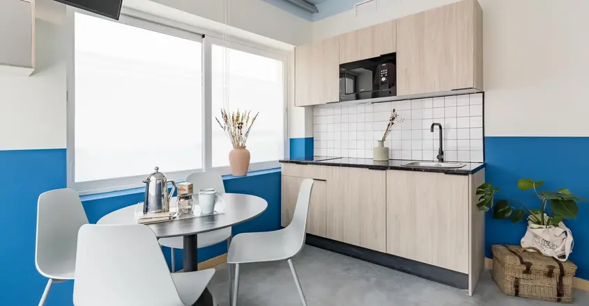 a kitchen with a table and chairs