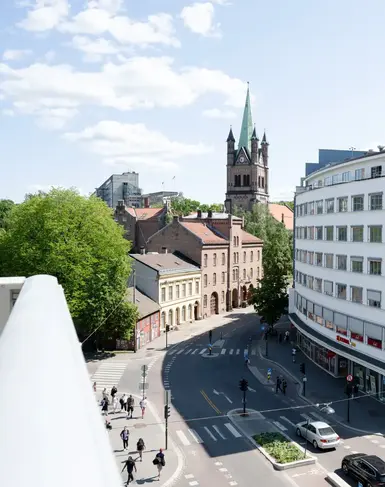 a street with cars and buildings in the background
