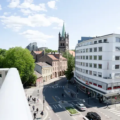 a street with cars and buildings in the background