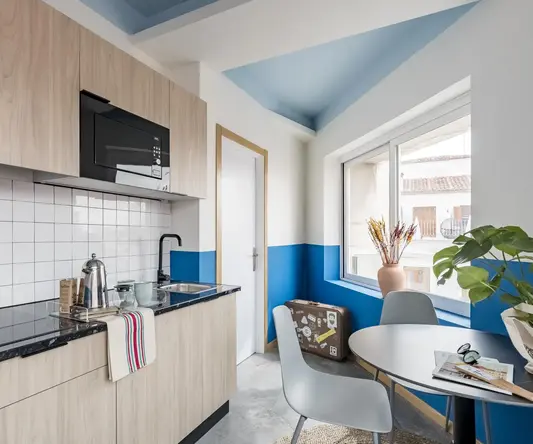 a kitchen with a table and chairs
