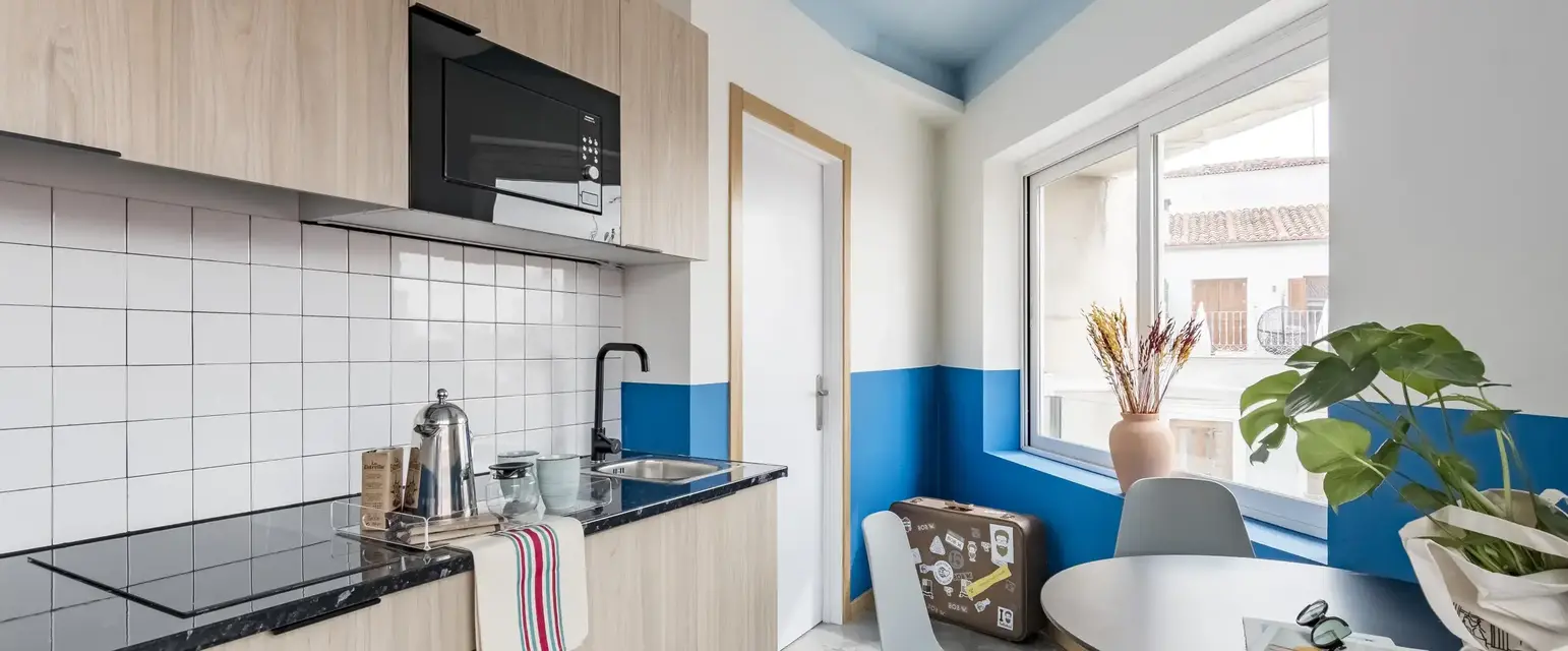 a kitchen with a table and chairs