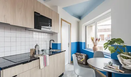 a kitchen with a table and chairs