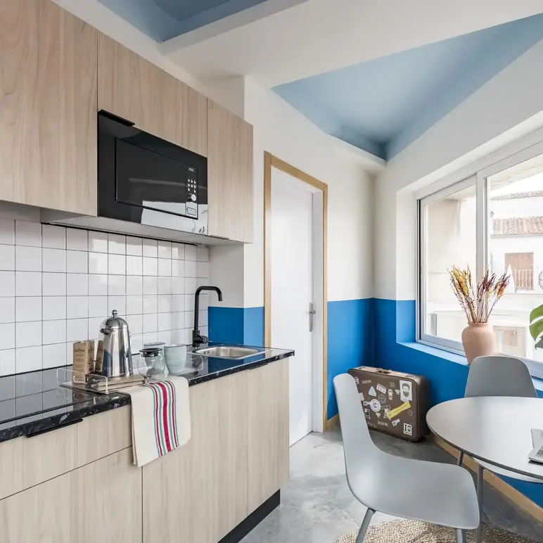 a kitchen with a table and chairs