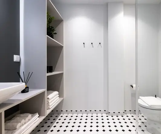 a bathroom with shelves and shelves